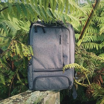 Nomad backpack surrounded by foliage