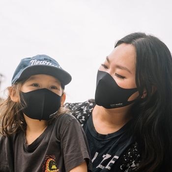Woman and child wearing black Pacsafe face masks