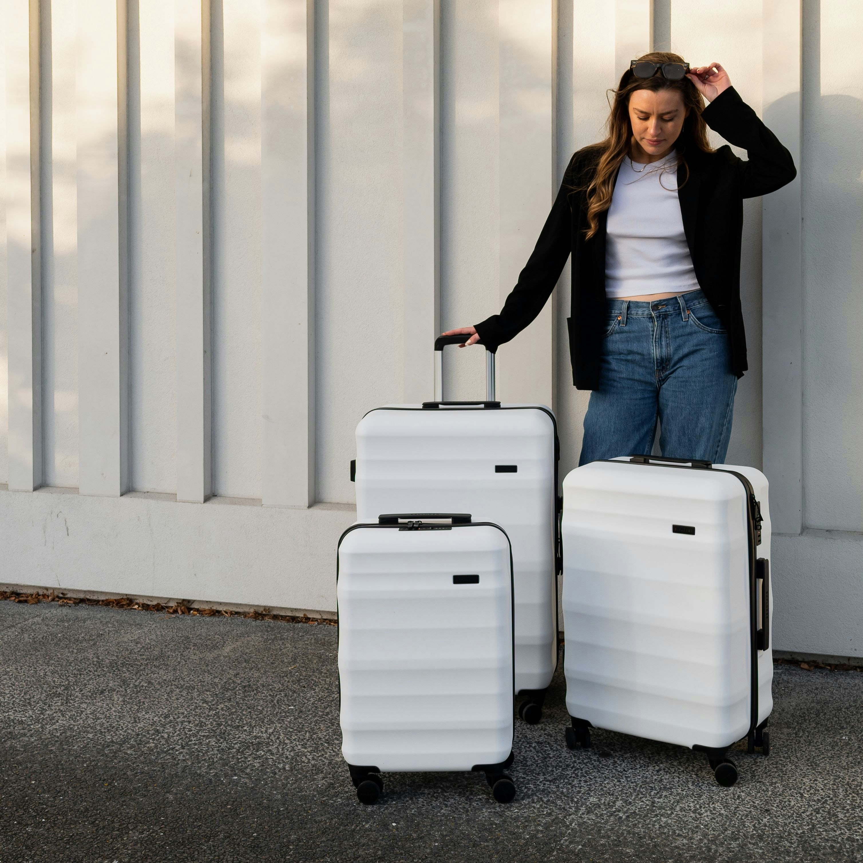 Girl with three white luna air suitcases by Explorer 