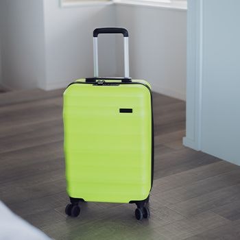 Explorer Luna-Air suitcase in neon lime in a house