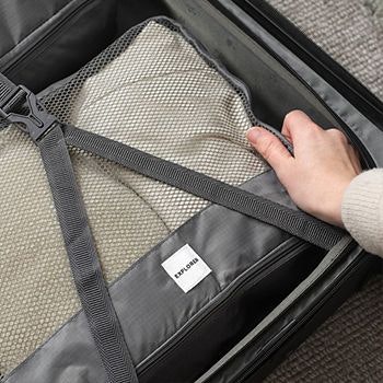 Grey Explorer Packing cube in a suitcase with compression straps done up