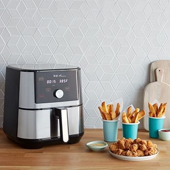 Instant Pot 5.7L Vortex Plus Air Fryer with chips and chicken next to it