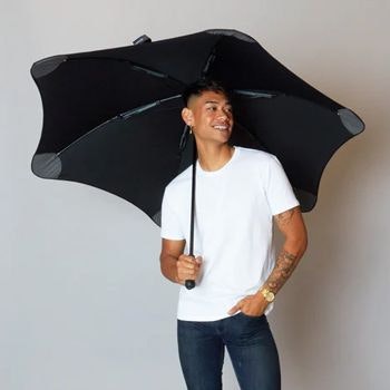Man smiling and holding a Black Exec Umbrella