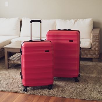 Hot Pink Explorer Luggage Set in a lounge