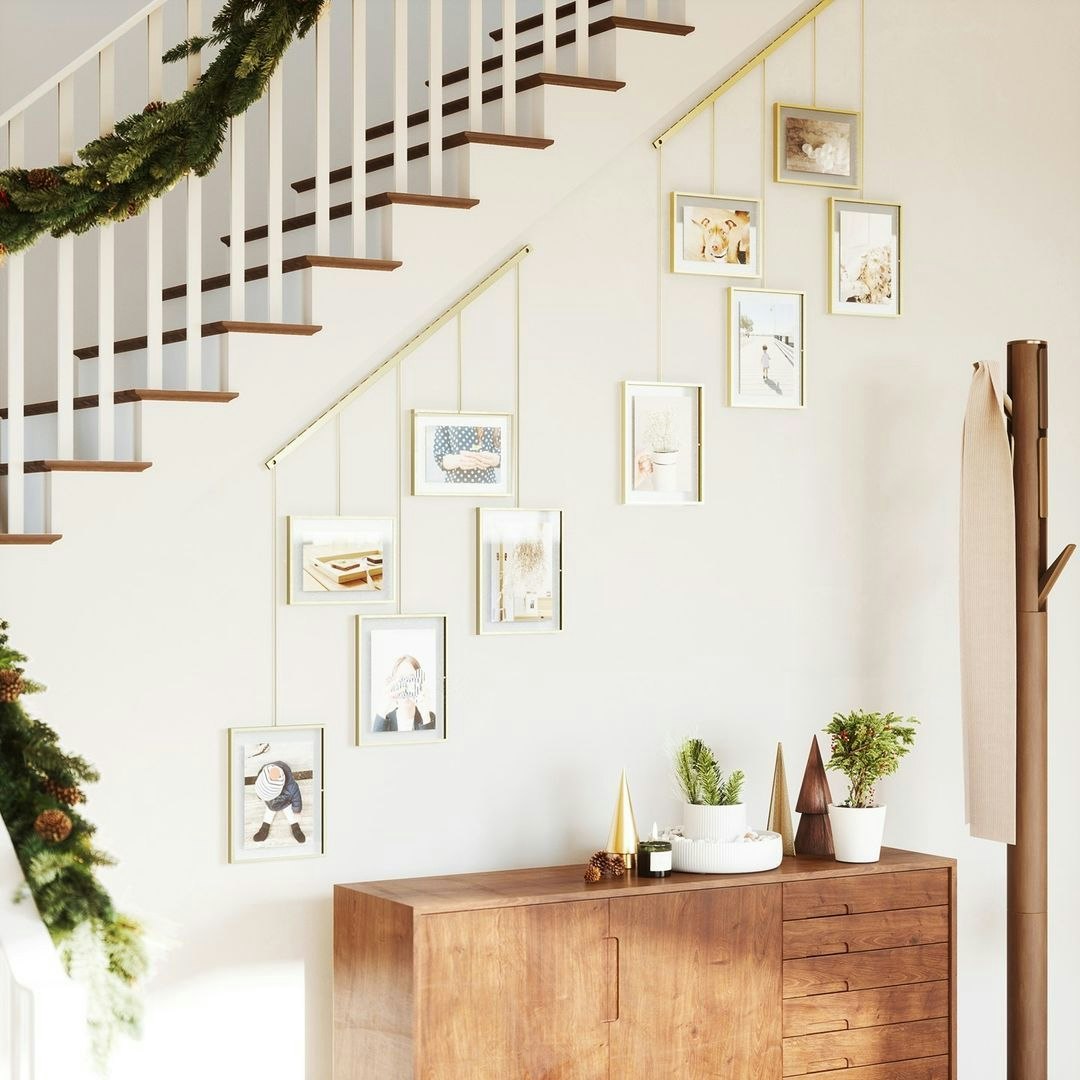 entrance way with hanging photo frames and decor