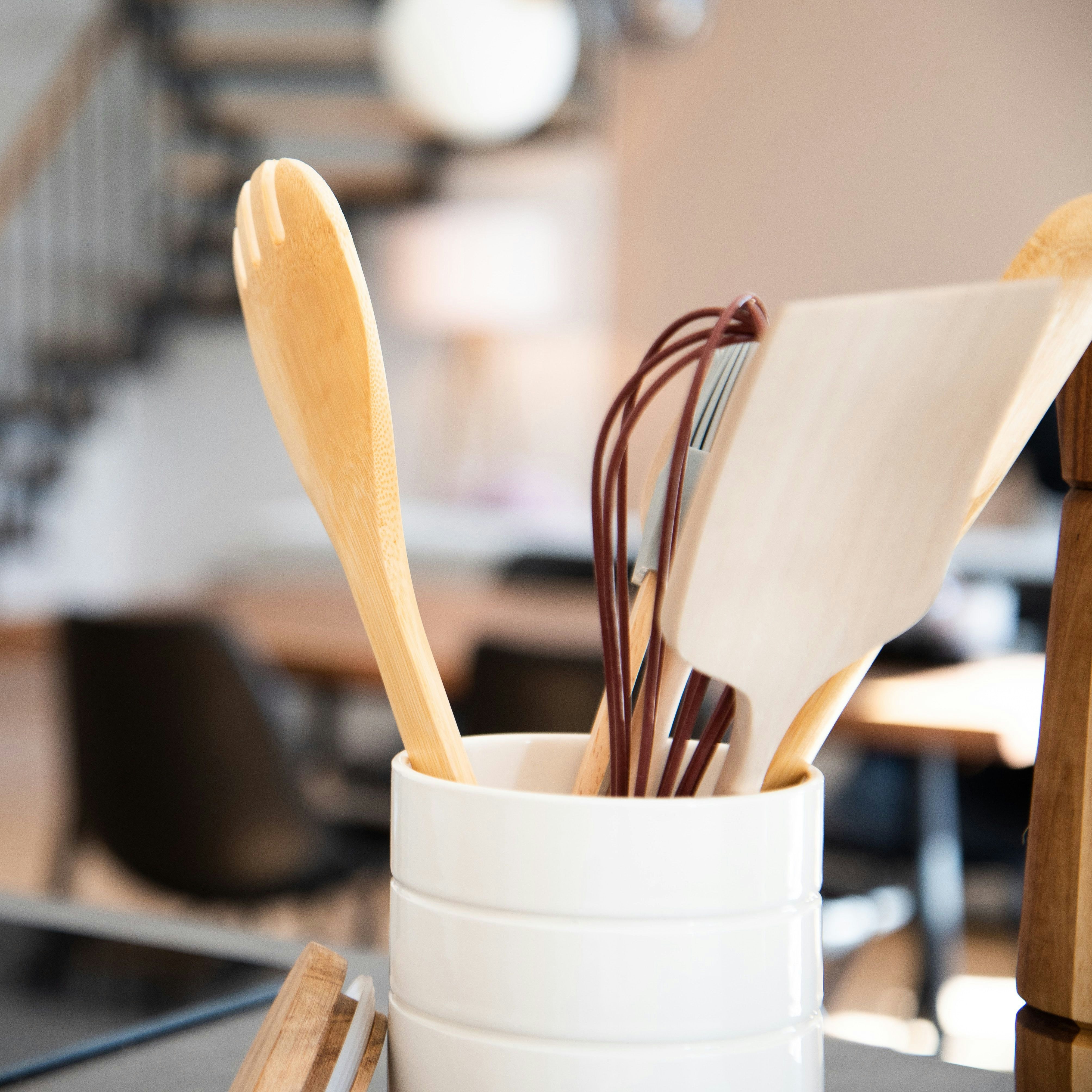 stand with kitchen utensils including wooden spoons 