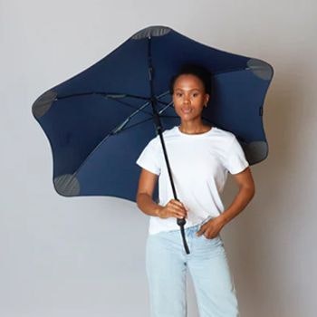 Woman holding the navy Blunt Classic Umbrella