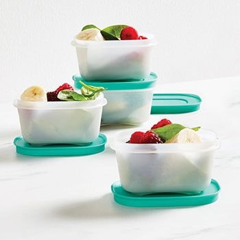 Three freezer keeper containers with fruit salad in it